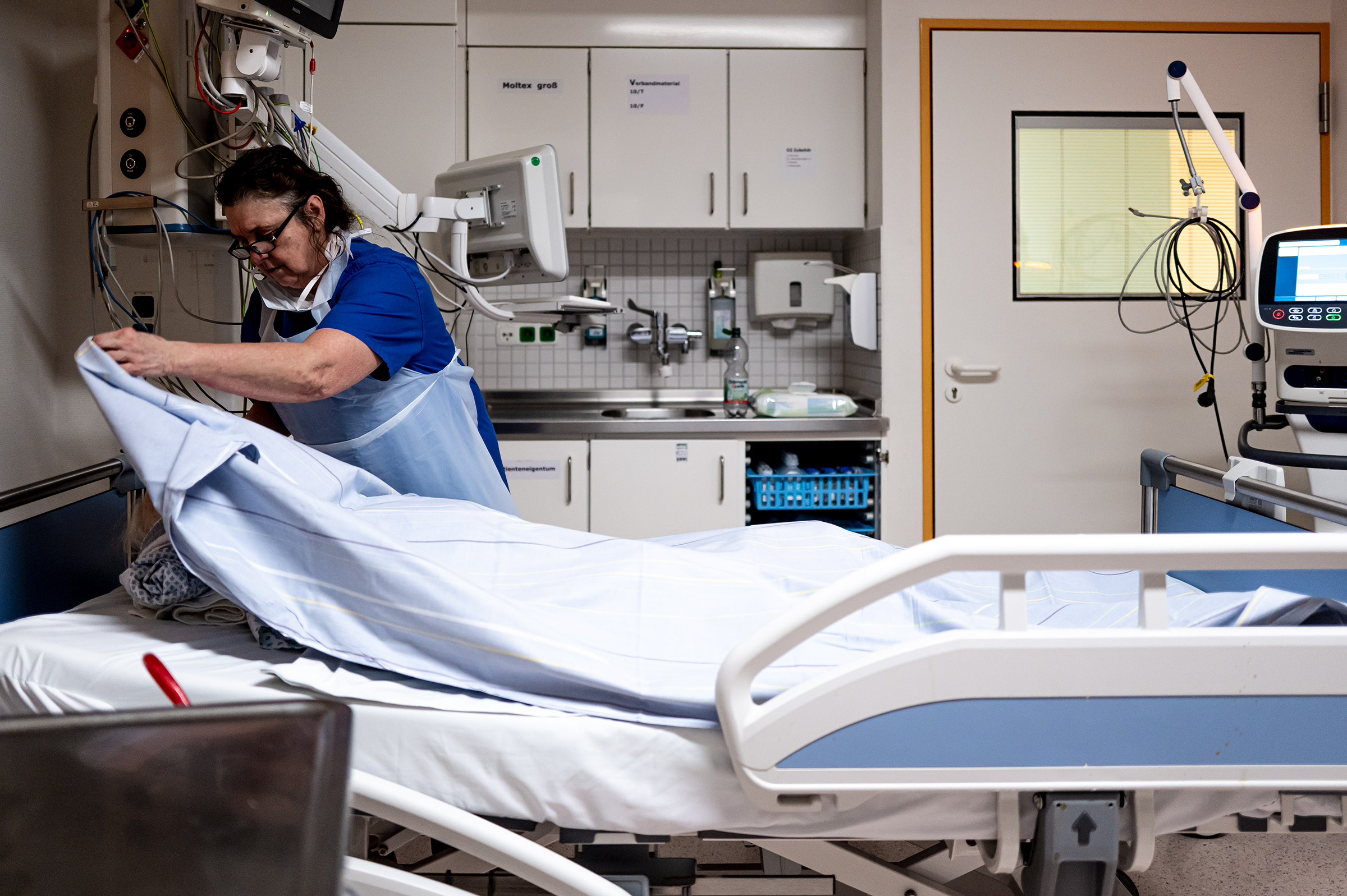 Ulrike deckt einen verstorbenen Patienten zu. Dieser wurde von seiner Familie verabschiedet, ehe die lebenserhaltenden Maßnahmen beendet wurden. 
